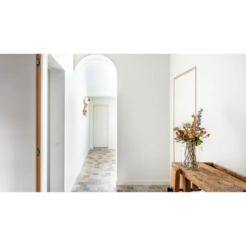 Arched doorway with white walls and tiled flooring featuring Ambachtelijke Adel mix 15x15