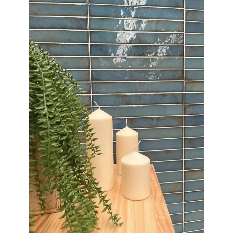 Drie roomkleurige ongeruite pilaarkaarsen op Brick Raku Turquoise mozaiektegel 35x35cm