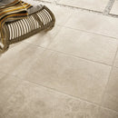 Beige stone tile flooring with a mottled pattern, perfect for Chantilly Creme 60x90 chip