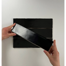 Hand pulling apart Colonial Black mats showcasing flexible design and style