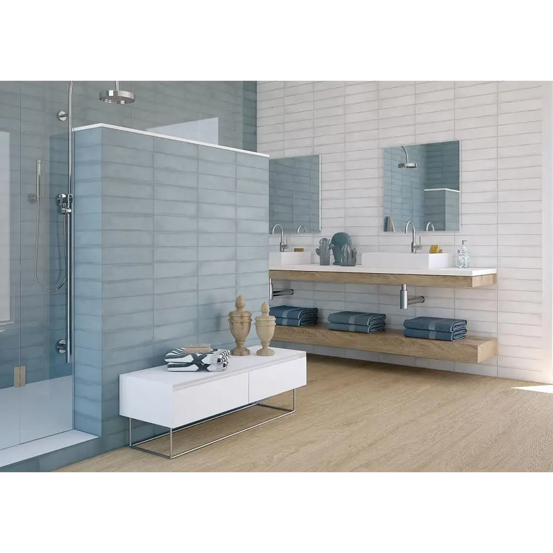 Modern bathroom with Colonial White mat tiles, floating shelves, and glass shower