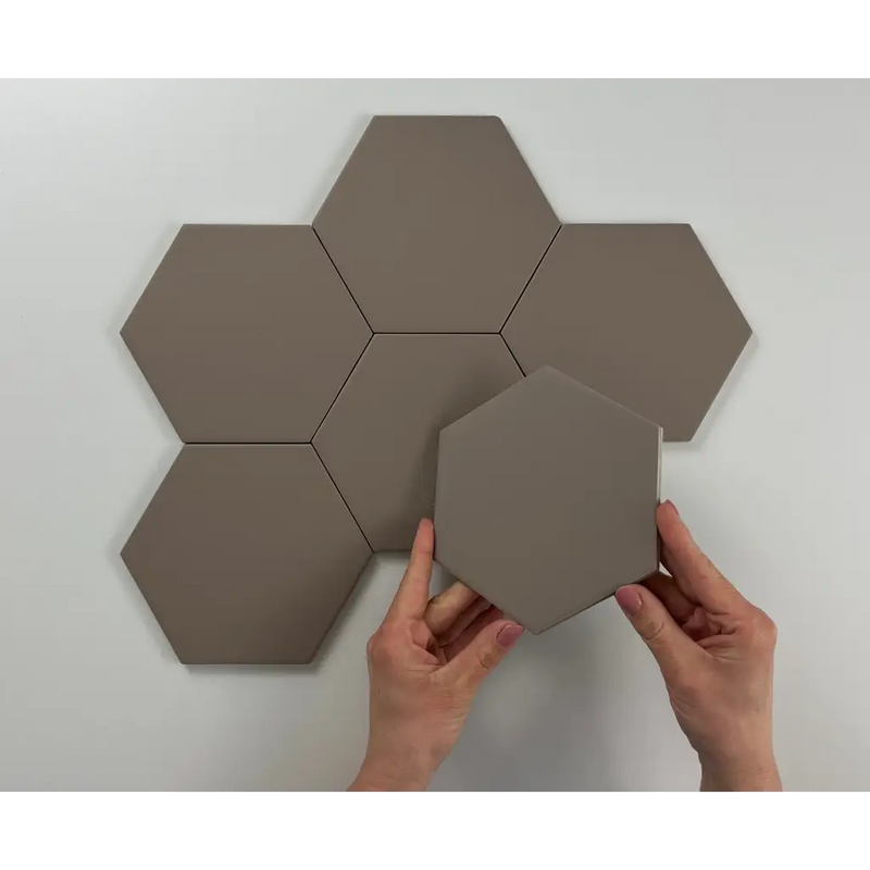 Hexagon Timeless Taupe mat 15x17 with hands placing a tile in a honeycomb pattern