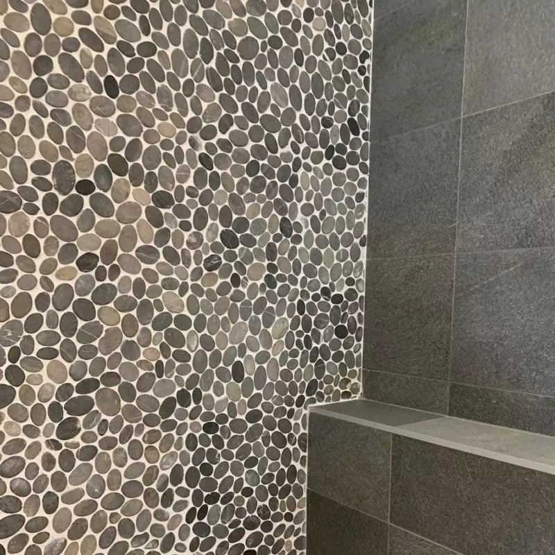 Pebble mosaic tile wall with NMP360 Dark Grey smooth tiles for stylish contrast