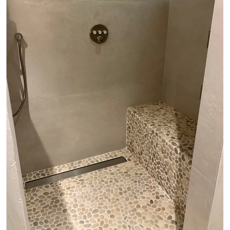 Mosaic stone pebbles crema 30x30 shower floor with built-in bench for a stylish look