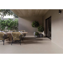 Woven rattan dining chairs with black metal legs paired with rift sand 60x120 rett flooring in a modern setting