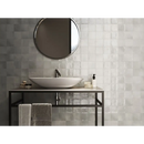 Oval vessel sink on a black metal vanity with glass shelf and Zellige Grey 10x10 tile