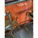 Chrome-plated metal chair with sleek design next to Zelliges Alhambra Oranje 10x10 cm