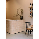 Curved bar with light tile cladding showcasing Zelliges Alhambra Bejmat Terracotta