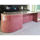 Curved pink-tiled counter with granite top, featuring Zelliges Alhambra Bejmat Vieux Rose